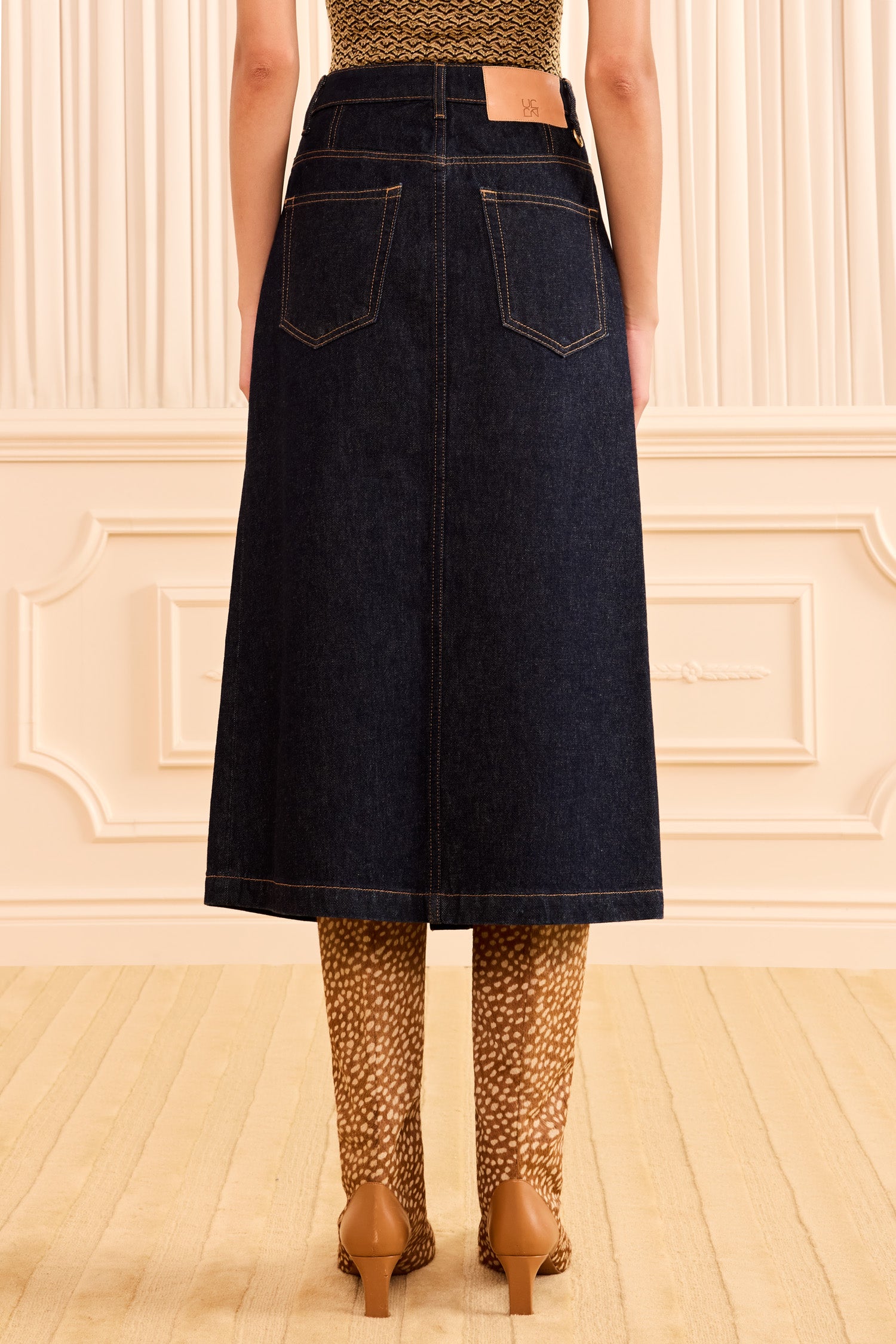 Ulla Johnson Tigris Dark Indigo Premium Denim Midi Skirt - On Model Back View, Leather Patch Detail | Ulla Johnson