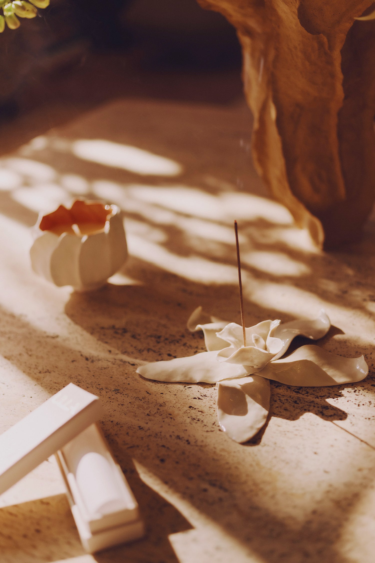 Ulla Johnson ULLA Luxury Incense Burning in Sun-Drenched Lifestyle Setting with Floral Ceramic Holder | Ulla Johnson